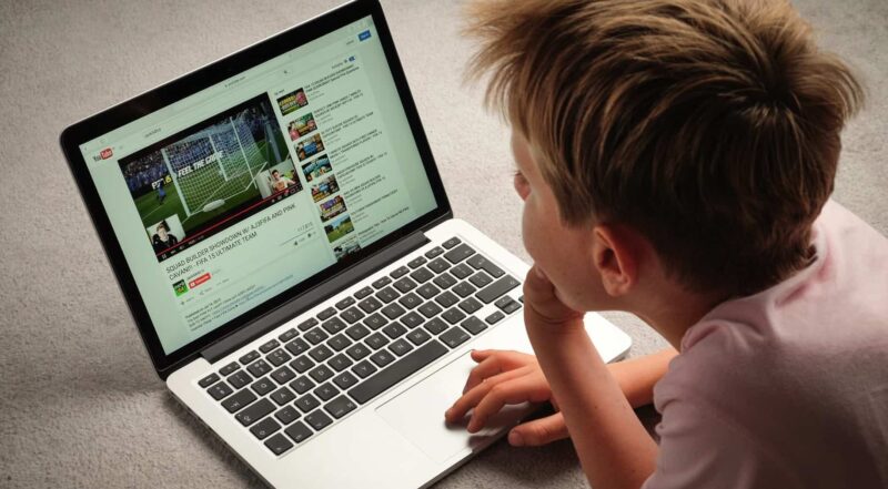 A Child watching Youtube videos on a laptop computer