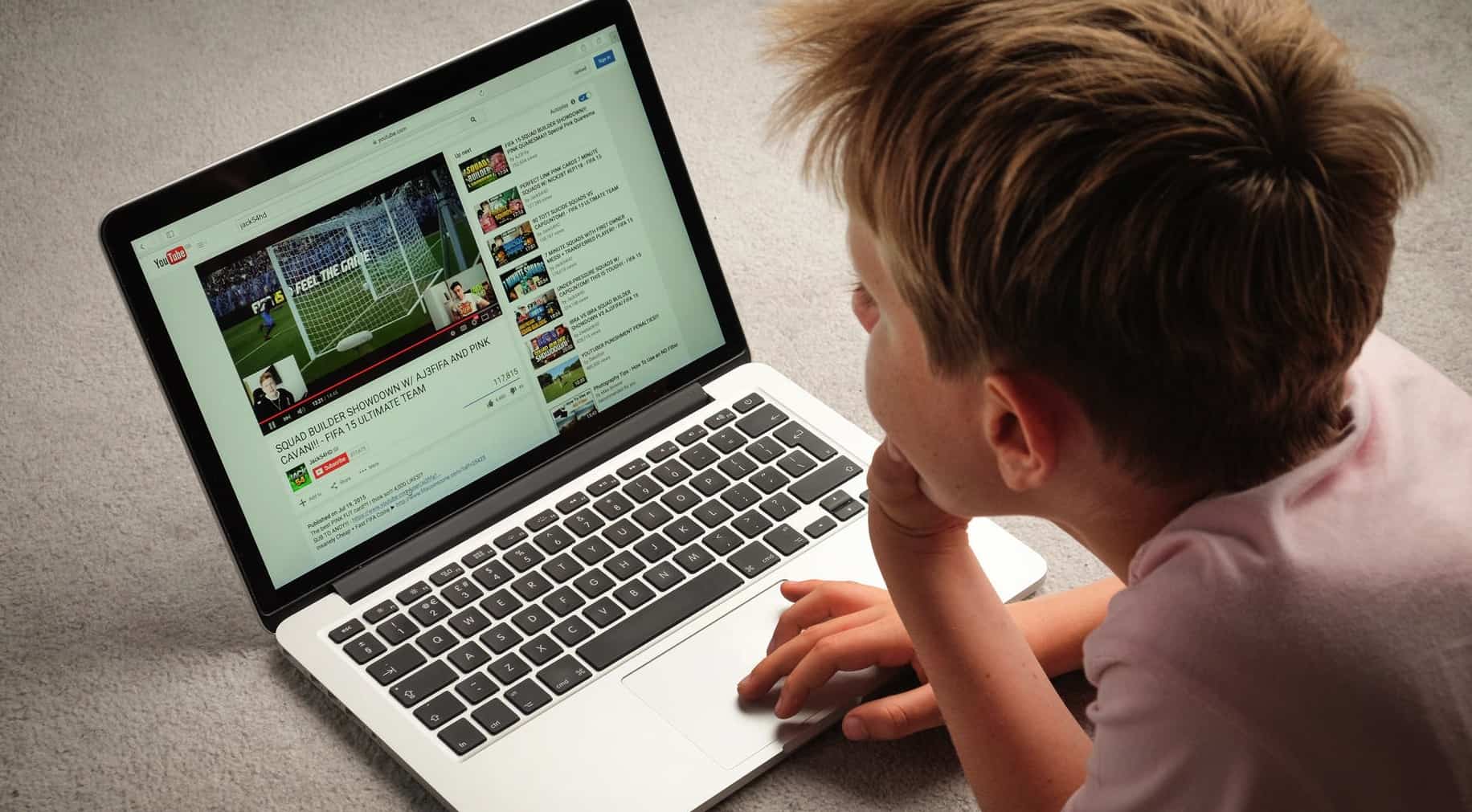 A Child watching Youtube videos on a laptop computer