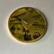 round gold colored ethereum ornament
